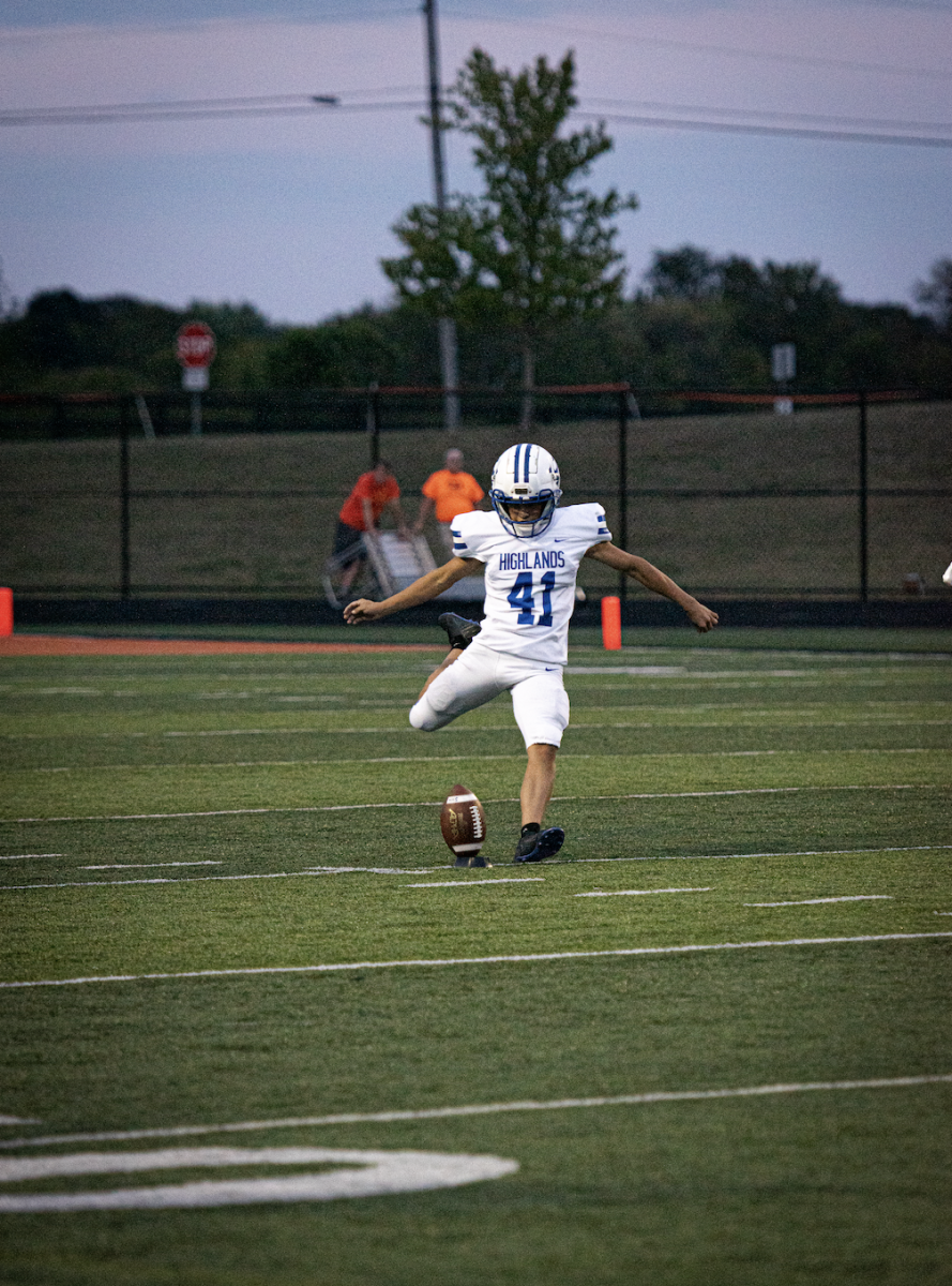 Kicker Logan Nickleman (12) kicks a field goal against the Ryle Raiders. 